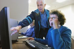 Two people using the computer