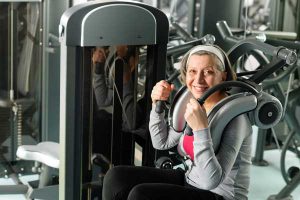 Lady exercising on gym equipment