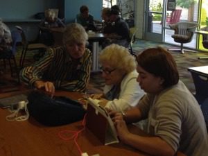 Three ladies using tablets