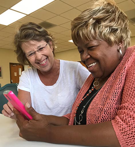 Donna teaching Angela how to user her phone - St Louis