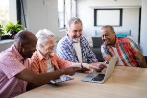 Instructor teaching older adults PC use